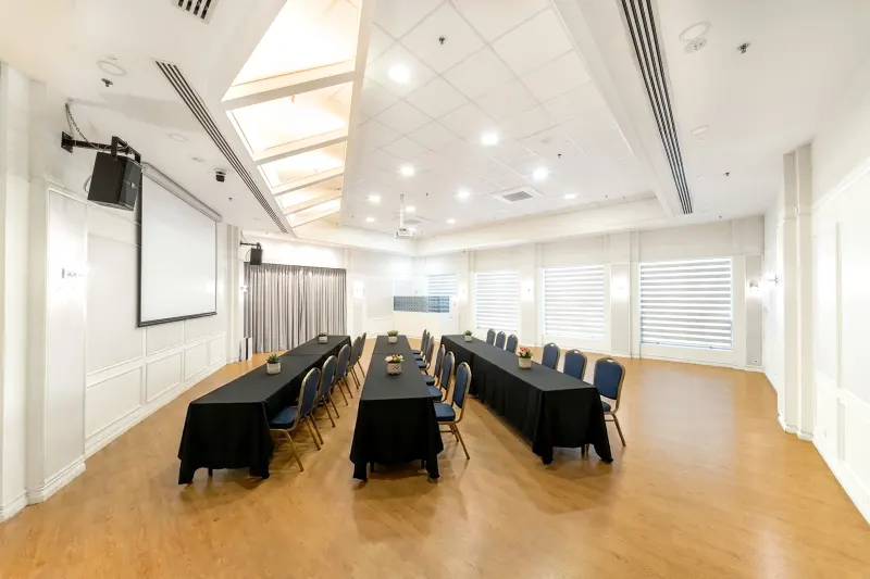 Function room interior view with tables and chairs set for a meeting