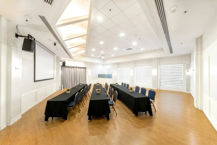 Function room interior view with tables and chairs set for a meeting